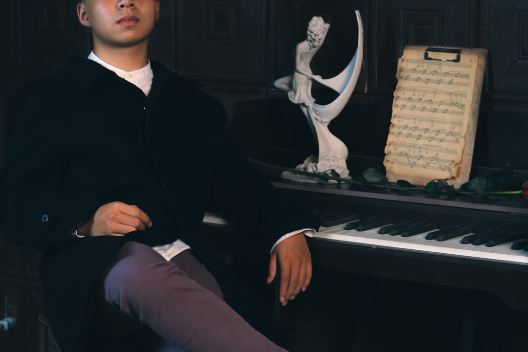 a man sitting in front of a piano